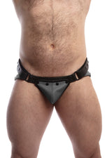 Front view of model wearing a black and grey leather jockstrap with matching coloured codpiece