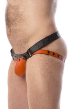 Front view of model wearing a black and orange leather jockstrap with matching coloured codpiece