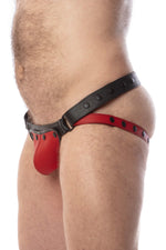 Side view of model wearing a black and red leather jockstrap with matching coloured codpiece