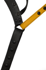 Flat view of front side of a black and yellow leather jockstrap
