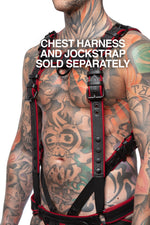 Chest harness sold separately. Model wearing a black and red leather combat harness and connector with black metal hardware. Side view.
