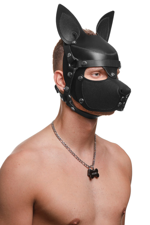 Model wearing a black leather pup mask and head harness with stainless steel hardware three quarter view