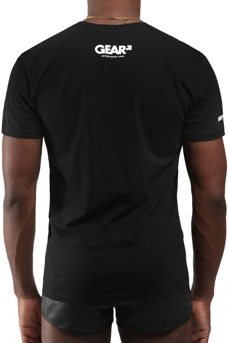 Model wearing black "TROUBLE SYDNEY" t-shirt. Front view.