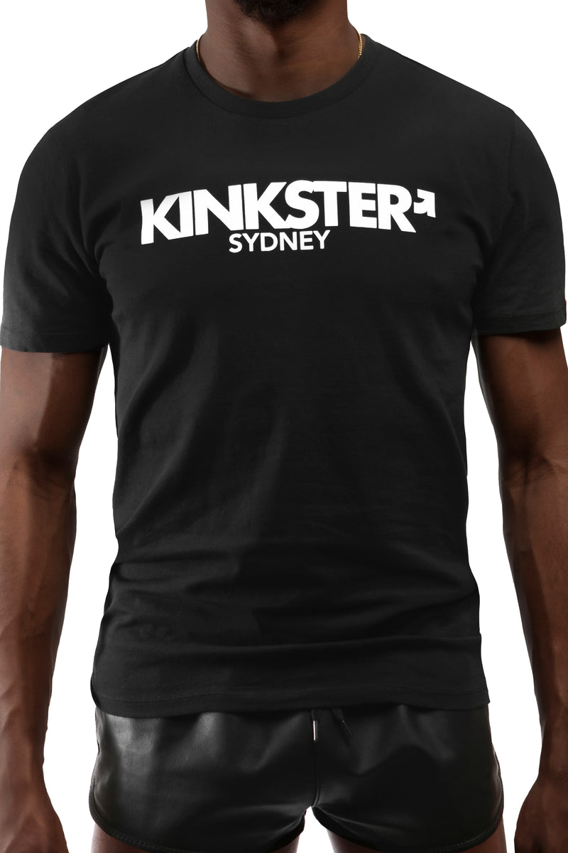 Model wearing black "KINKSTER SYDNEY" t-shirt. Front view.