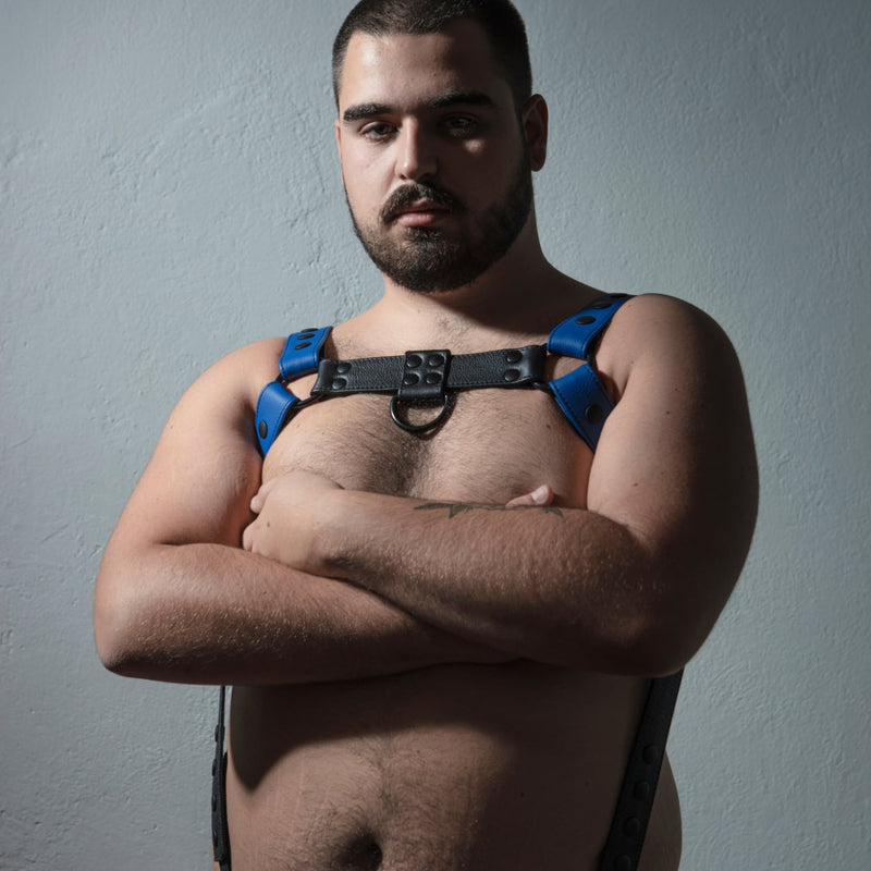 Blue and Black leather harness on a plus sized bearded male model