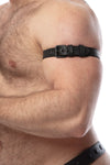 Detailed side view of a model wearing a CLASSIC ARMBELT NARROW - Black finished with matte black hardware.