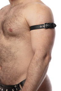 A male model turned sideways wearing a 1" wide black leather buckled armband and stainless steel hardware.