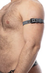 Profile image of a hairy model wearing a CLASSIC ARMBELT NARROW - Grey with matte black hardware.