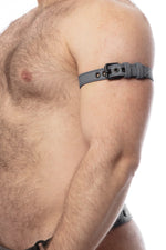 Model wearing a 1" wide grey leather armband belt with matt black hardware