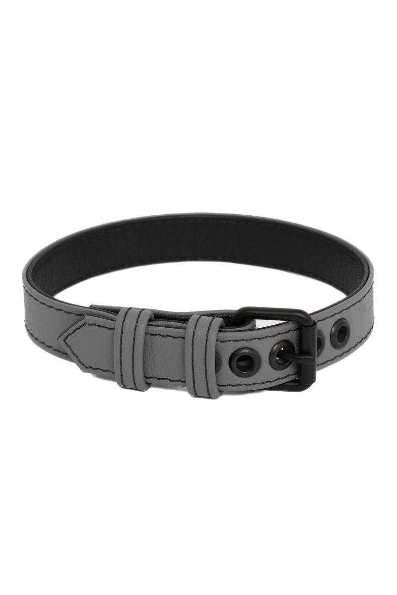 A grey leather buckled armband finished with matte black components, formed into a loop.