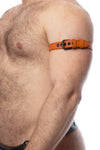 A model facing sideways displays a 1" wide orange leather armband belt with matte black hardware.