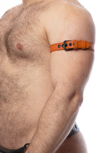 A model facing sideways displays a 1" wide orange leather armband belt with matte black hardware.