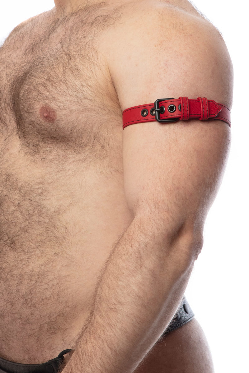 Model wearing a 1" wide red leather armband belt with matt black hardware