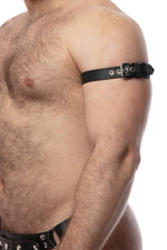 Model wearing a 1" wide black leather armband belt with stainless steel hardware