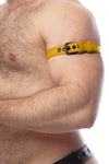 Tight-angled shot of a thick model in a yellow leather armbelt featuring matte black details.