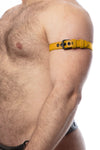 A side view of a model wearing a 1" wide yellow leather armband with matte black hardware.