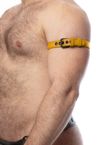 A side view of a model wearing a 1" wide yellow leather armband with matte black hardware.