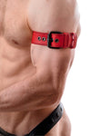 Tight-angled shot of a European model in a red leather armband belt featuring matte black details.