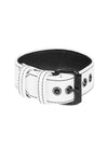 A white leather armband with matte black hardware is shown in a curl.