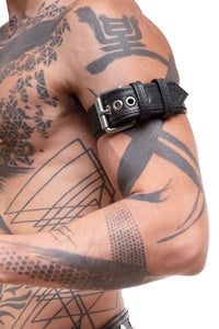 Detailed side view of a model wearing a COMBAT ARMBELT - Stainless Steel finished with stainless steel hardware.