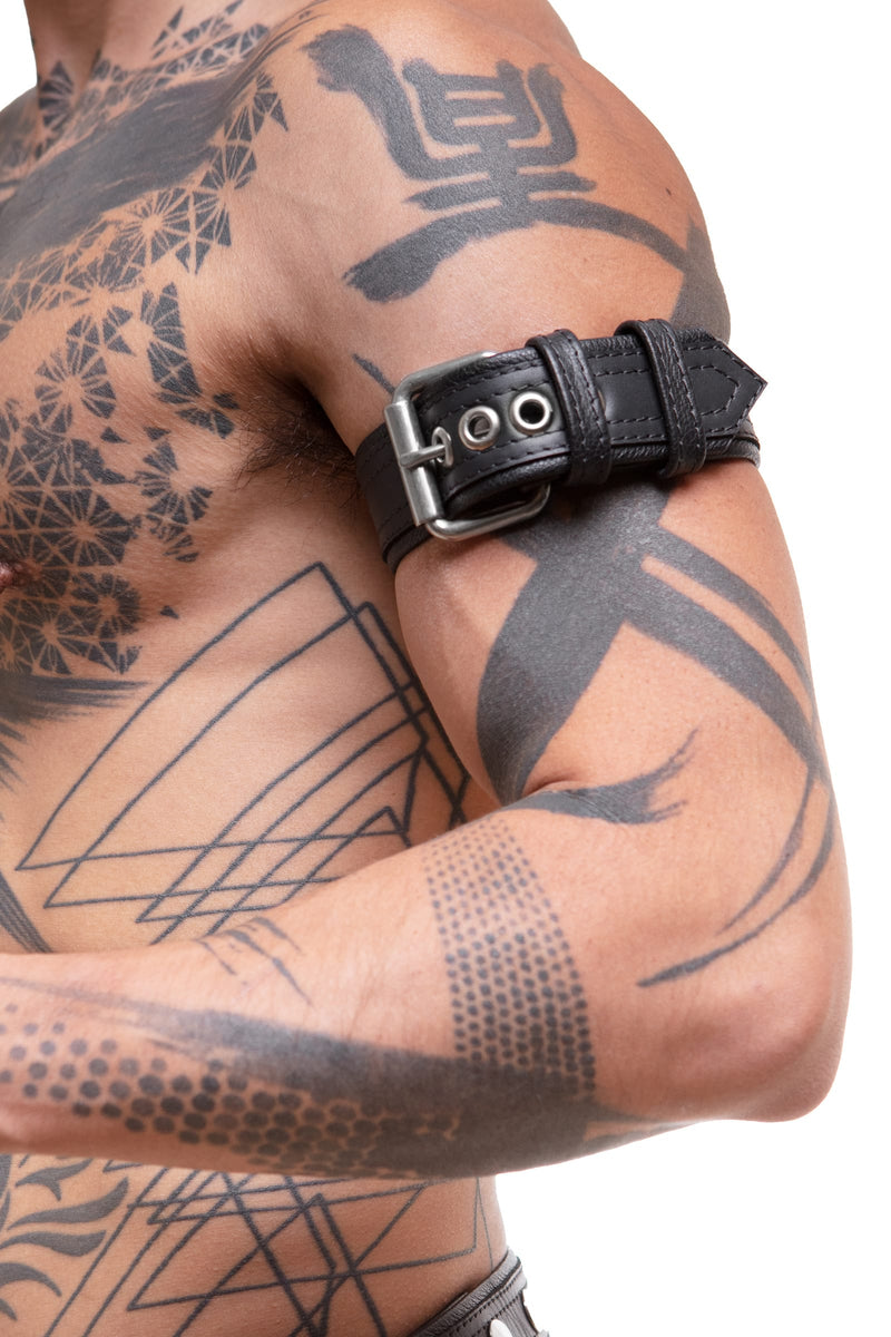 Detailed side view of a model wearing a COMBAT ARMBELT - Stainless Steel finished with stainless steel hardware.