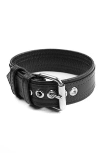 A curled black leather armbelt with stainless steel components.