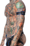 A black and blue leather armbelt with matte black hardware on a toned model, captured from the side.