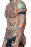 A male model turned sideways wearing a 1" wide black and blue leather armband and matte black hardware.