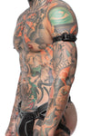 Captured from the side, a model wears a 1" wide grey leather armbelt with matte black hardware.