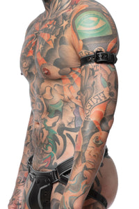 Captured from the side, a model wears a 1" wide grey leather armbelt with matte black hardware.