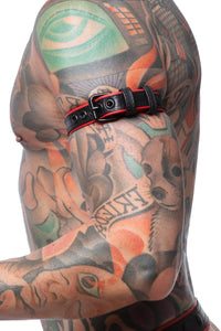 Tight profile shot of a model fitted in a 1" wide black and red leather buckled armband with matte black buckle.