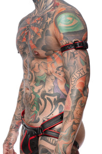 A 1" wide black and red leather buckled armband with matte black hardware styled on a model.