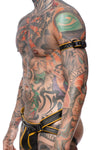 A toned model wearing a 1" wide black and yellow leather armband belt turned to show matte black hardware.