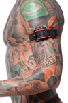 Close-side perspective of a model wearing a black and orange leather armbelt with matte black hardware.