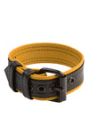 A 1.5" wide COMBAT ARMBELT - Yellow with matte black hardware standing in a ring shape.