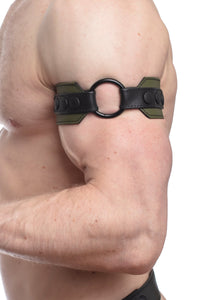A 2" wide army green and black leather armband with a matte black O-ring captured side-on in a close-up.