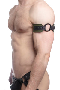 An army green and black leather armband with matte black hardware on a muscular model, captured from the side.