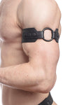 Profile close-up showing a model in a black leather armband detailed with matte black hardware.