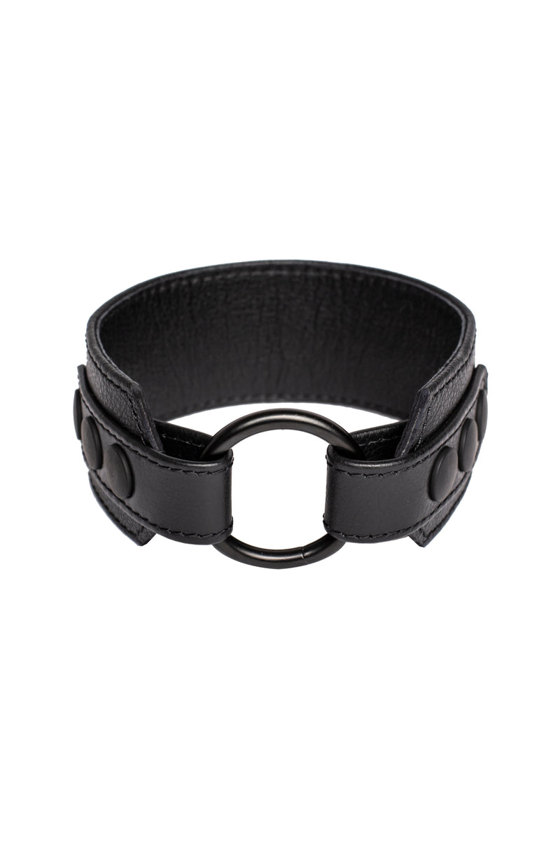 A 2" wide black leather armband with matte black snaps, looped into a ring.