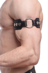 Profile close-up showing a model in a black leather armband detailed with stainless steel hardware.