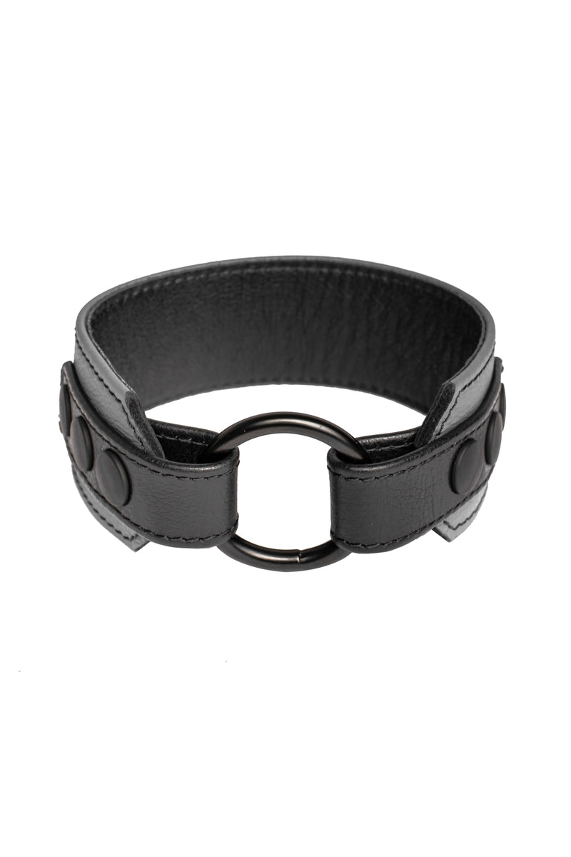 A 2" wide grey and black leather armband with matte black hardware, in a coil.