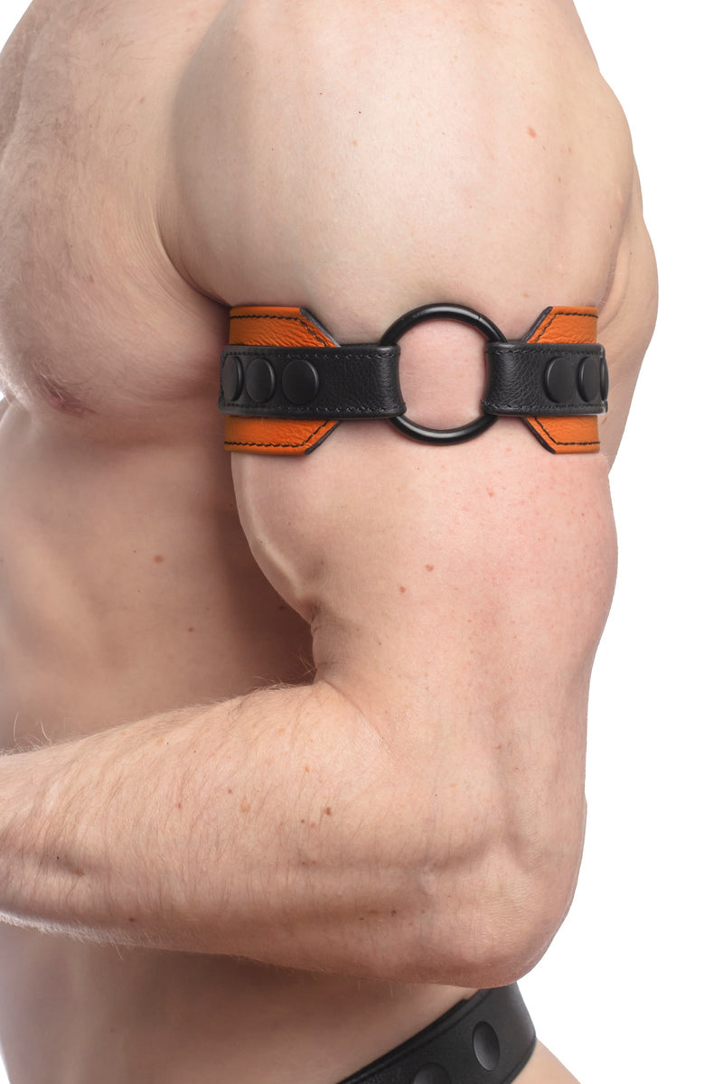 Side close-up of a chiselled model showing a 2" wide orange and black leather armband with matte black hardware.