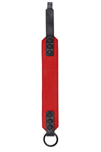 Flat-laid shot of a 2" wide O-RING ARMBAND - Red finished with matte black hardware.
