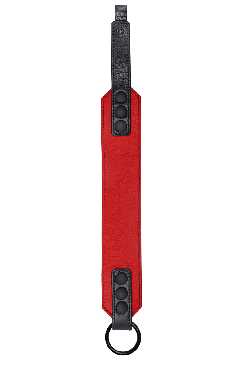 Flat-laid shot of a 2" wide O-RING ARMBAND - Red finished with matte black hardware.