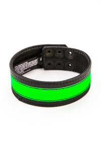 A black and fluro green leather armband with matte black hardware is shown in a curl.