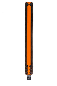Flat-laid and facing up, a 1.5" wide black and fluro orange leather armband with matte black hardware.
