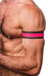 Zoomed side shot showing a model styled in a 1.5" wide black and fluro pink leather armband with matte black hardware.