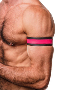 Zoomed side shot showing a model styled in a 1.5" wide black and fluro pink leather armband with matte black hardware.