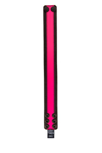 Flat and front-facing, a 1.5" wide black and fluro pink leather armband fitted with matte black hardware.