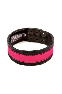 A black and fluro pink leather armband with matte black hardware is shown in a curl.